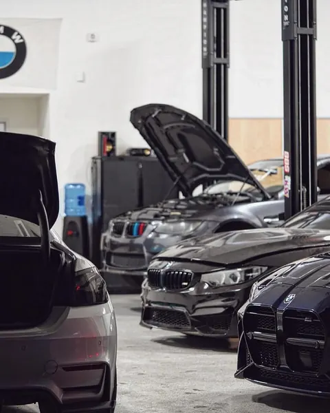 BMWs parked inside the EuroWorks shop during the Open Haus meet